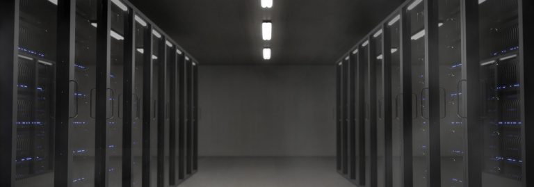 Persistent Systems Q2 results: a dimly lit data centre aisle lined with rows of server racks