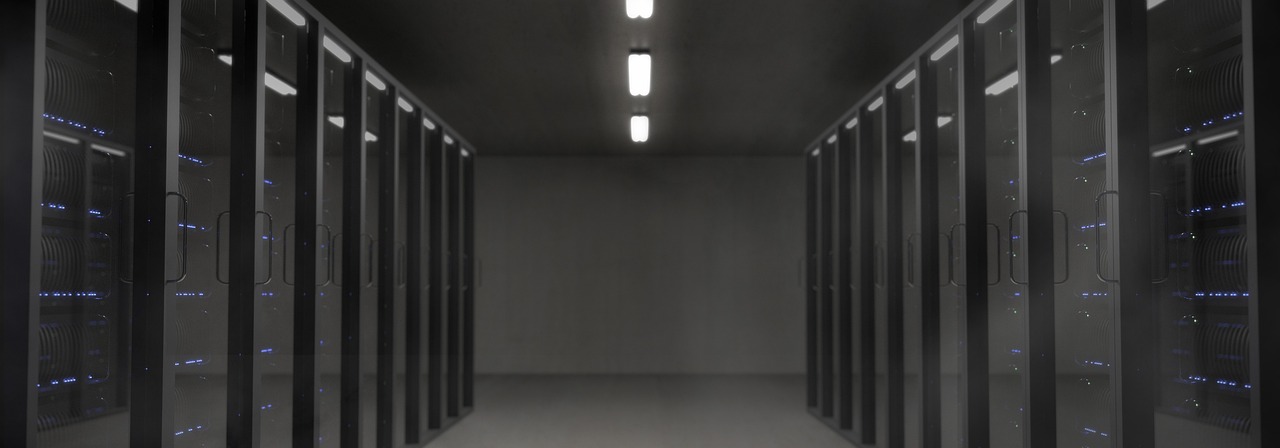 Persistent Systems Q2 results: a dimly lit data centre aisle lined with rows of server racks