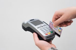 Pine Labs Q2 results: a customer pays by card on a handheld payment terminal