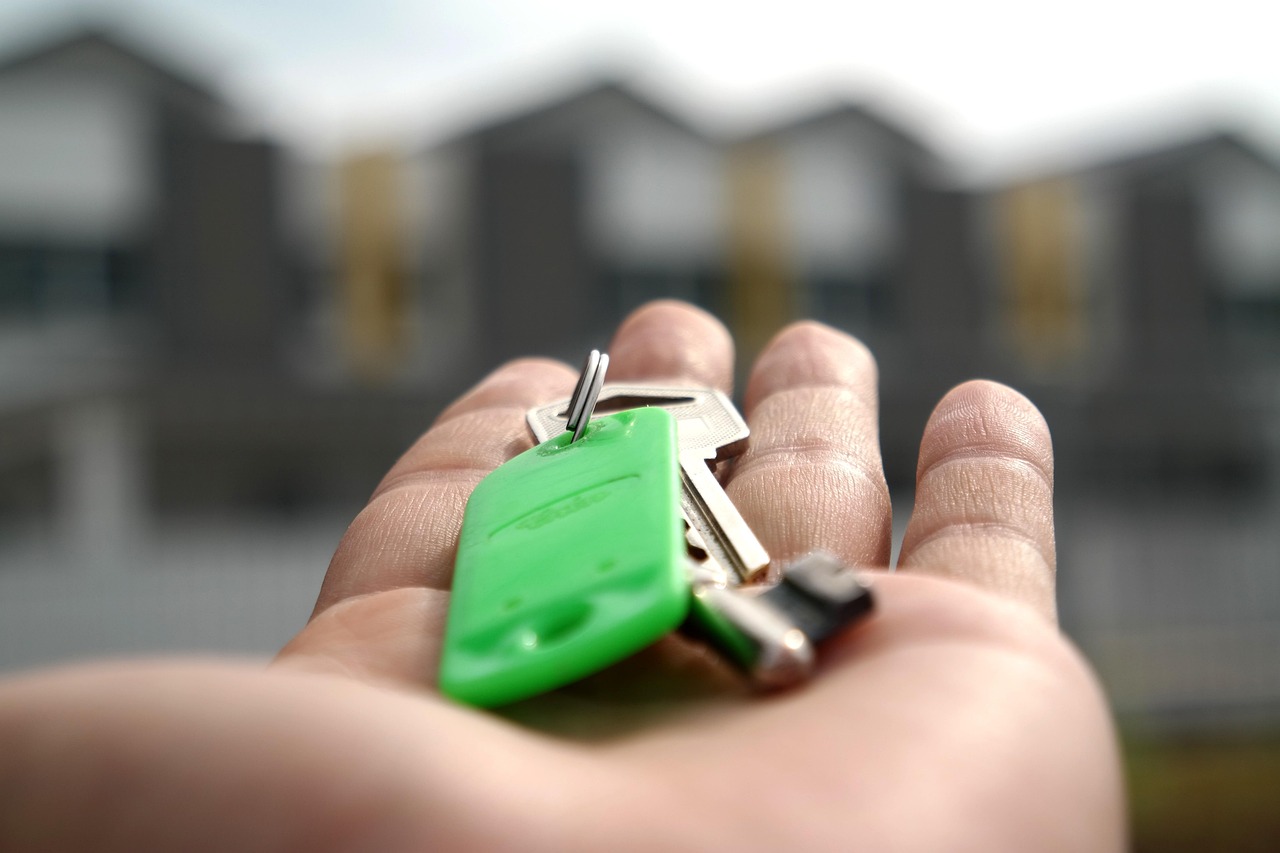 Piramal Finance Q2 results: house keys resting on an open palm in front of a row of new homes