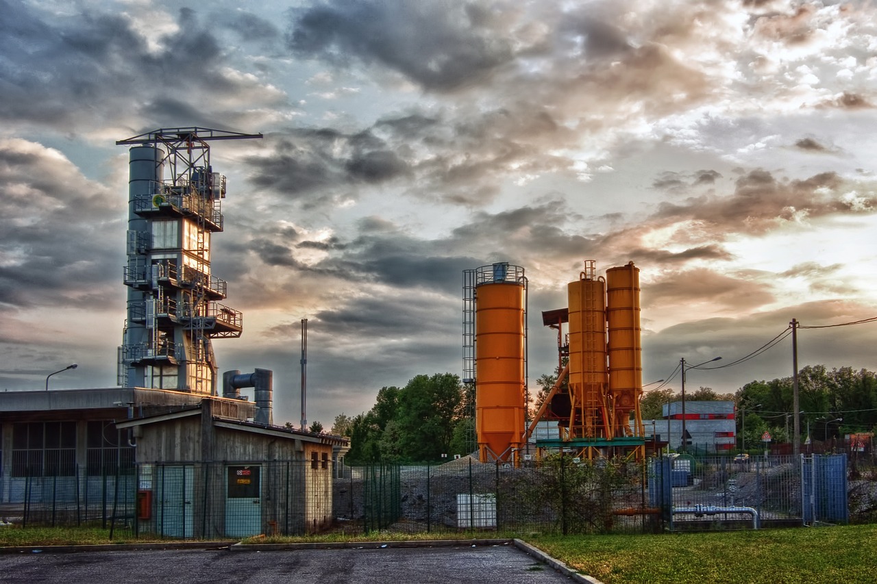 Q2 results today October 19: orange cement silos and an industrial plant under an evening sky