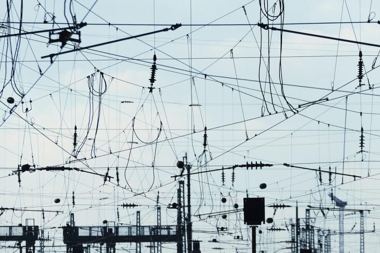 RailTel Q2 results: overhead railway cables and electrical lines criss-crossing above a station yard