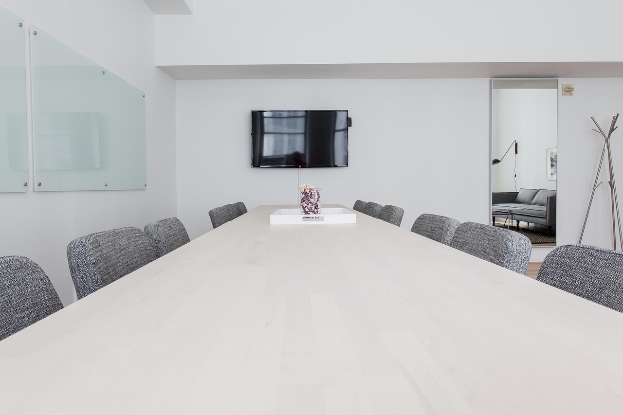 Related party transactions in results: an empty boardroom with a long table and chairs where an audit committee meets to approve deals