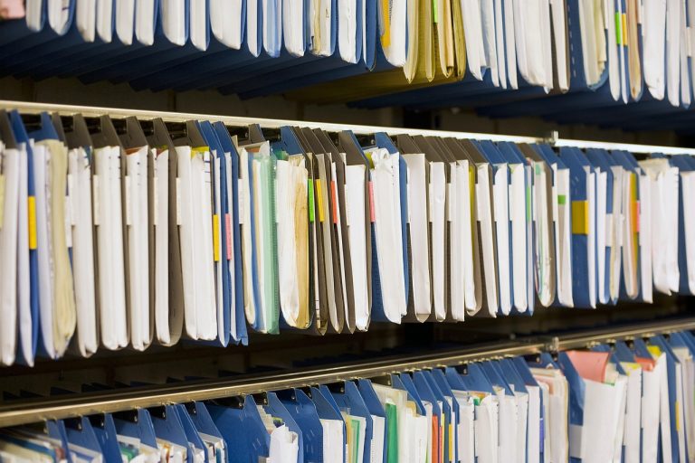 Restated financial statements IPO concept: shelves of filed company records and documents in an archive