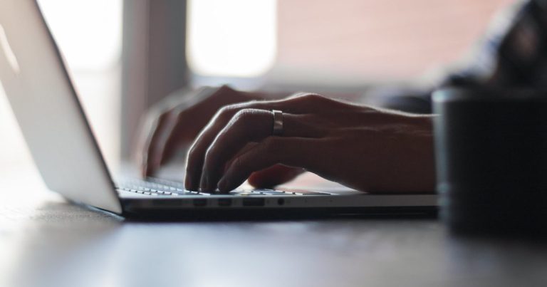 Risk reward ratio in trading - laptop typing hands