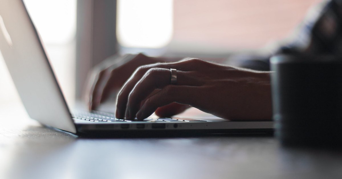 Risk reward ratio in trading - laptop typing hands