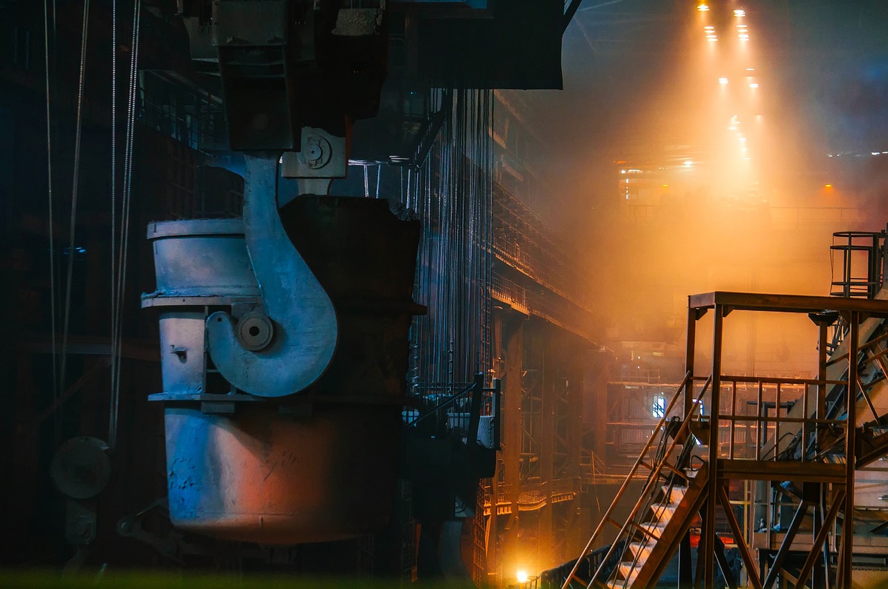 SAIL Q2 results: ladle and walkways inside a steel plant lit by orange furnace glow
