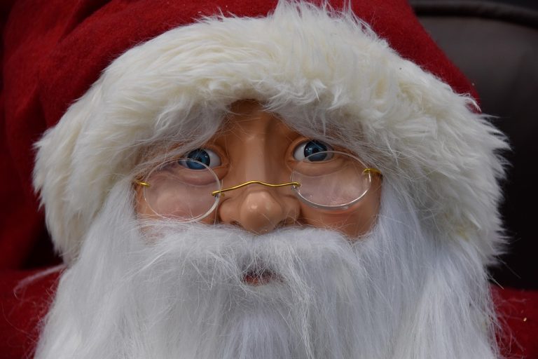Santa Claus rally concept: close-up of a Father Christmas figure with white beard and glasses