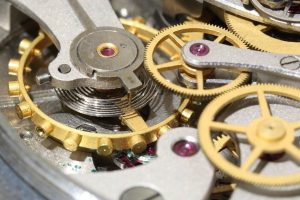 Schaff trend cycle: close-up of brass gears and balance wheel inside a mechanical stopwatch