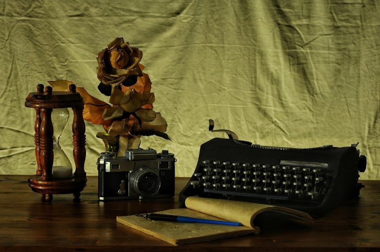 SEBI observation letter for an IPO shown as an hourglass beside a vintage typewriter, camera and open notebook on a desk