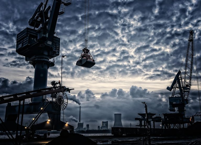 Sector rotation strategy: port cranes and an industrial skyline under a cloudy sky