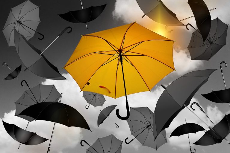 Segregated portfolio mutual fund side pocket: one yellow umbrella set apart among grey and black umbrellas