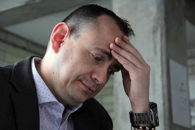 Sensex Nifty October 19: a worried investor in a suit holding his forehead after a market fall