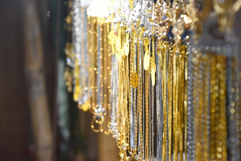 Sky Gold Q2 results: rows of gold and silver chains hanging in a jewellery shop