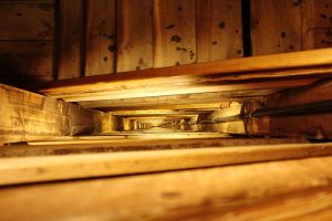 Three inside up pattern concept: looking up a long wooden staircase rising floor by floor