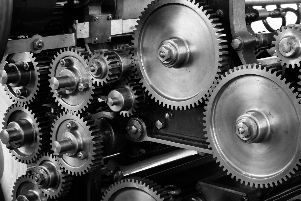Tobin's Q ratio: interlocking steel gears inside industrial machinery