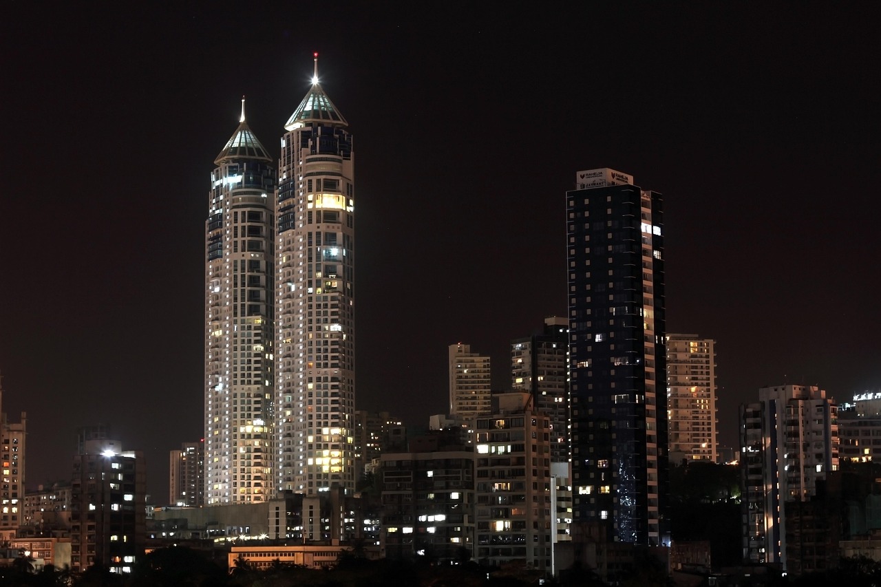 Most valued firms market cap: high-rise towers lit up at night on the Mumbai skyline