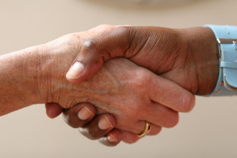 Total contract value: two business people shaking hands to close an IT services deal
