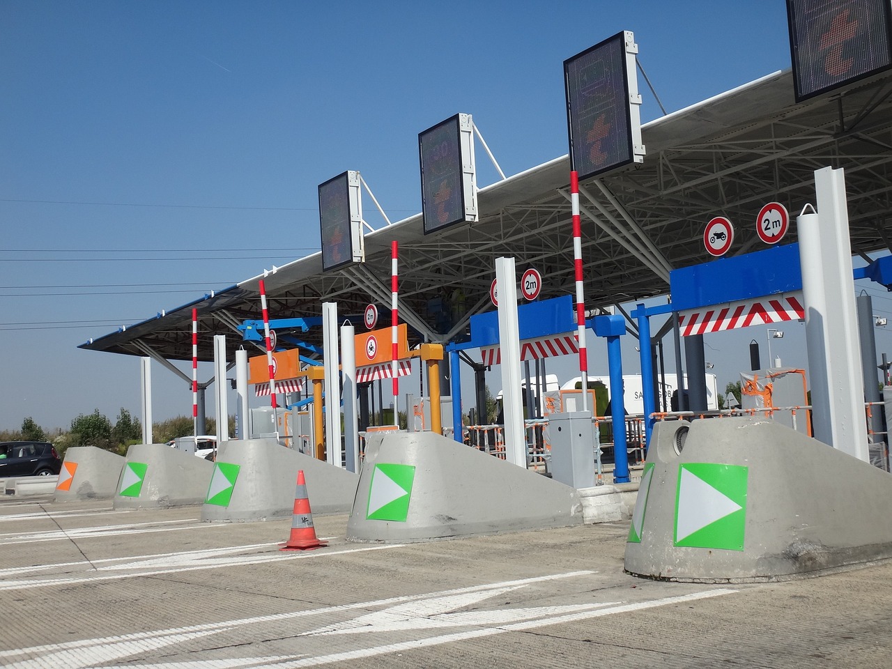 Trade for trade segment NSE: separate toll lanes with barriers at a highway toll plaza, each vehicle cleared one at a time