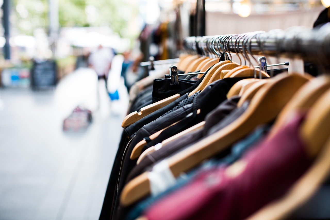 Trent Q2 results: jackets and shirts on wooden hangers at a clothing store rack