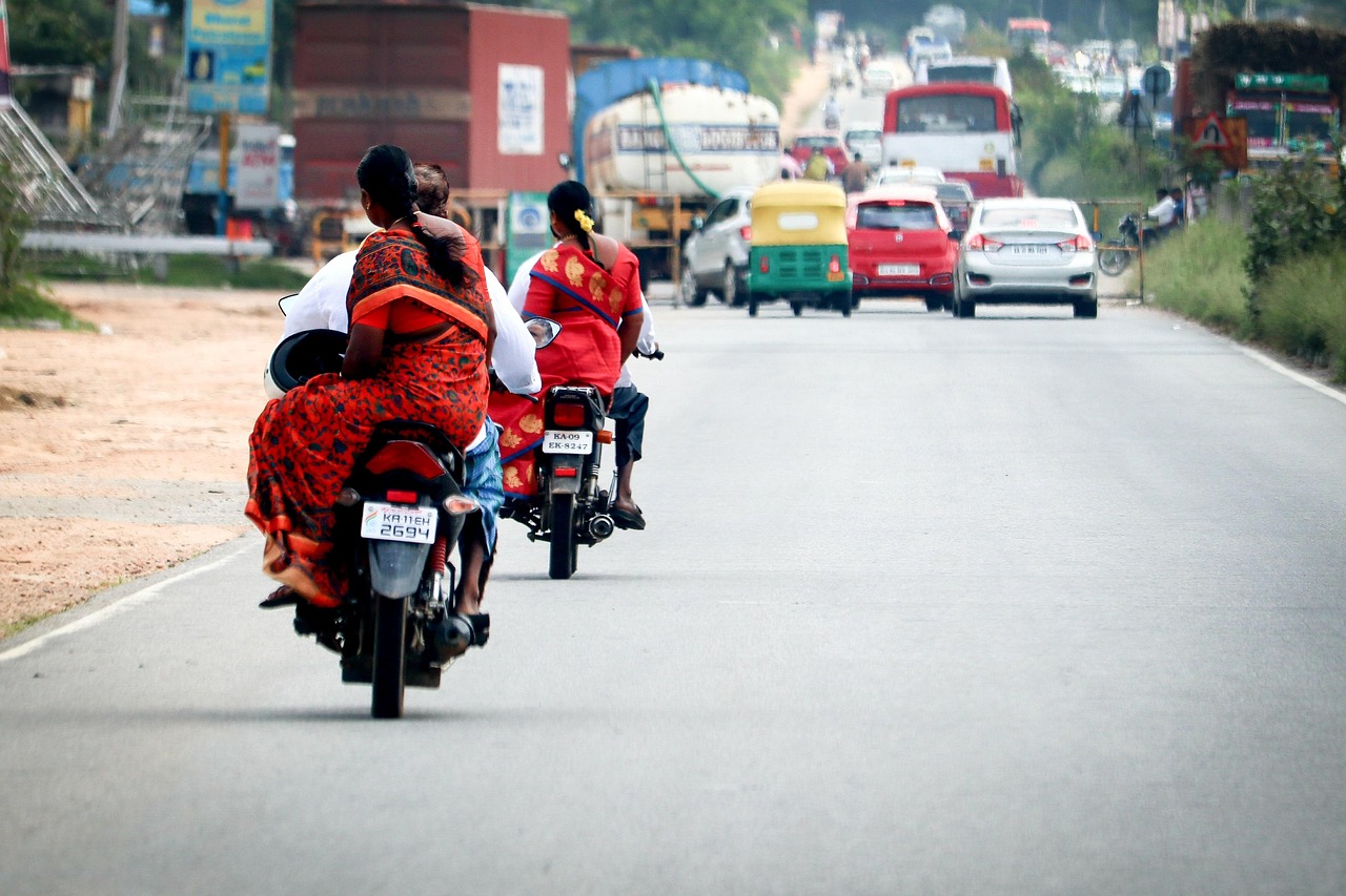 TVS Motor Q2 results: motorcycles and an auto-rickshaw on a busy Indian highway