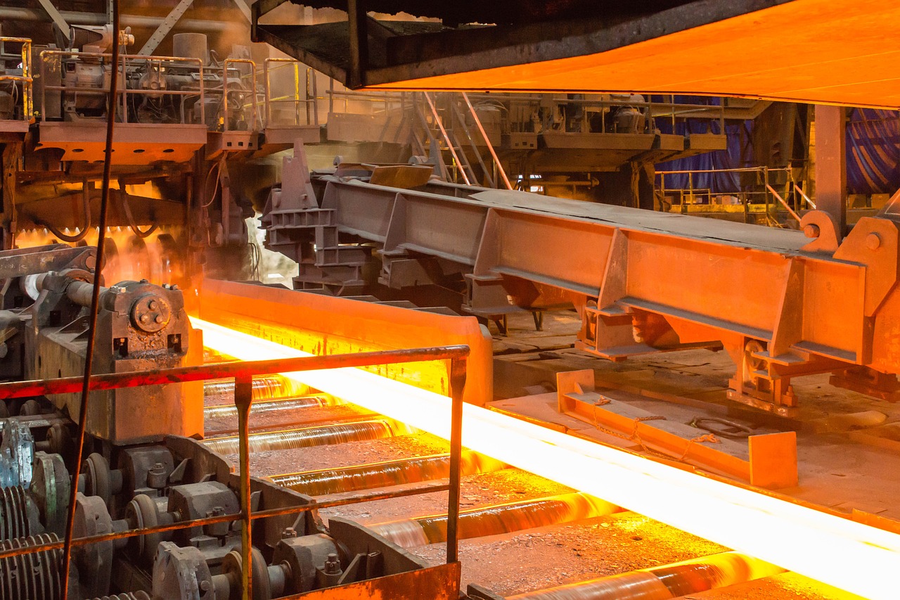 Vardhman Special Steels Q2 results: glowing hot steel moving along the rollers of a rolling mill
