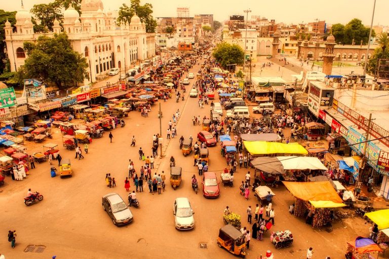 Volume profile trading: crowds gathering around street stalls in a busy Hyderabad market seen from above
