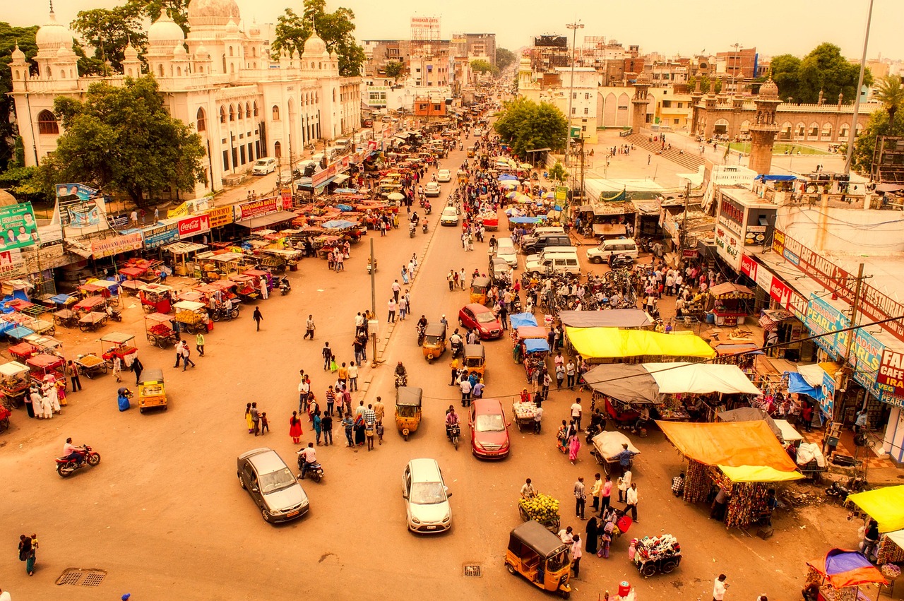 Volume profile trading: crowds gathering around street stalls in a busy Hyderabad market seen from above