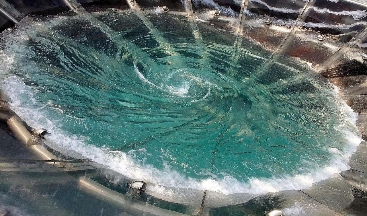 Vortex indicator: a swirling turquoise water vortex in a circular basin