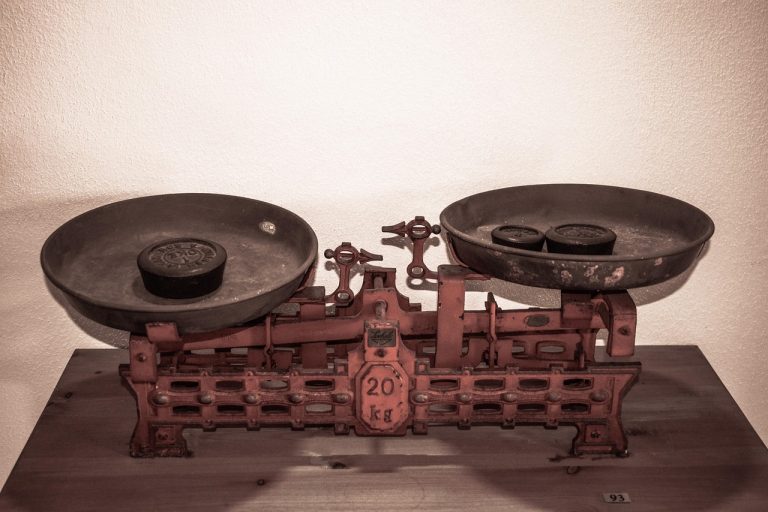 Volume price trend indicator concept: an antique two-pan weighing scale with iron weights