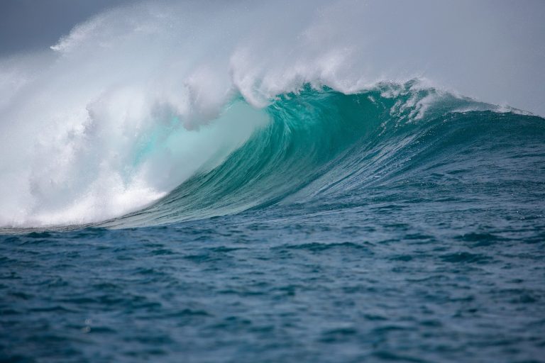 Elliott wave theory: a large ocean wave curling and breaking at sea