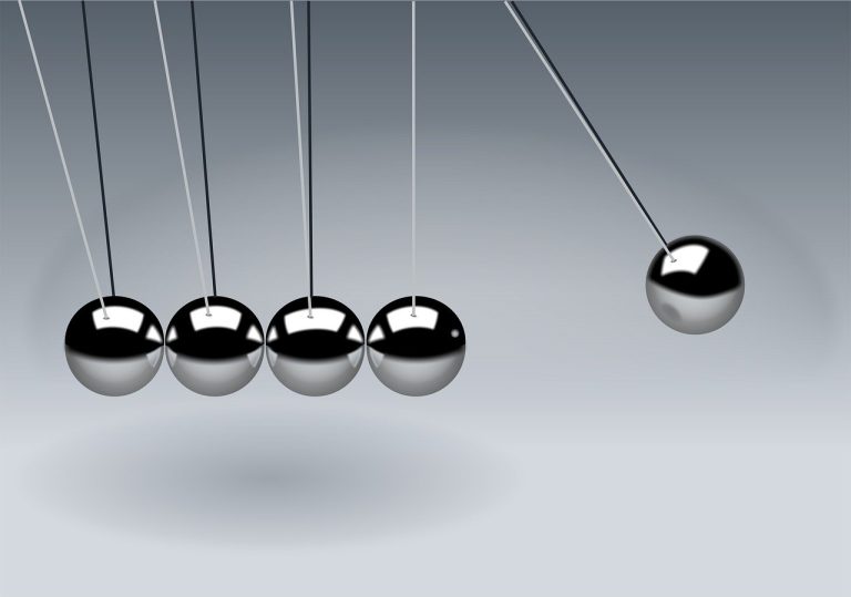 Williams %R indicator: a Newton's cradle with one steel ball swung out to the edge, a symbol of momentum reaching an extreme