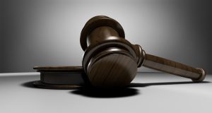 Winner's curse in IPO: a wooden auction gavel resting on its sound block