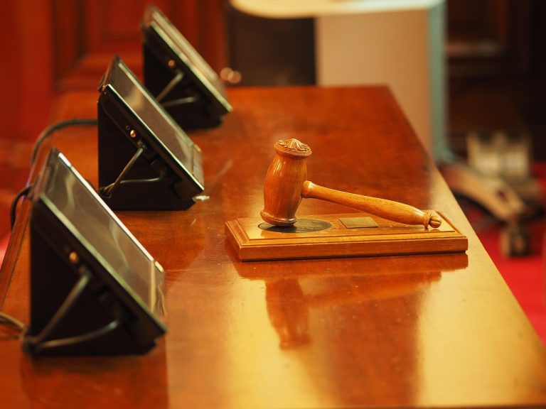 Yes Bank Q2 results October 17: wooden judge gavel on a polished courtroom bench beside microphones