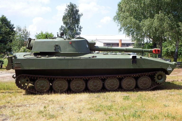 Zen Technologies Cogknit acquisition: a green tracked armoured vehicle parked on grass